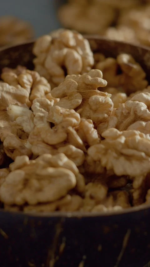 Vertical video Explore the rich texture and flavor of fresh walnut kernels in a Stock Footage 329617748