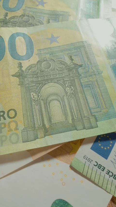 Vertical video Exploring the intricate details of the 100 euro banknote in close Stock Footage 327596686