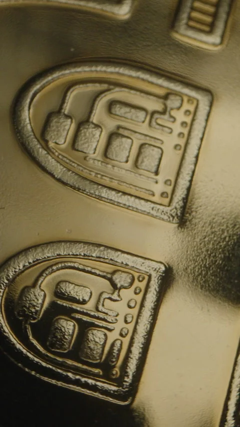 Vertical video. Extreme Close-Up of Bitcoin Coin, Focused on Its Textured Logo Stock Footage 296505110