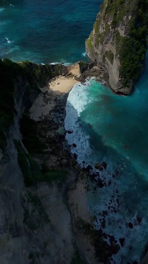 Vertical video. Extreme FPV Drone Dive From Cliff Edge Above Diamond Beach On Nu Stock Footage 336634478