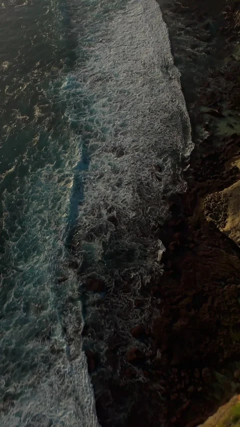 Vertical video. Extreme FPV Drone Dive Down Karang Boma Cliff Toward Powerful Oc Stock Footage 336636354
