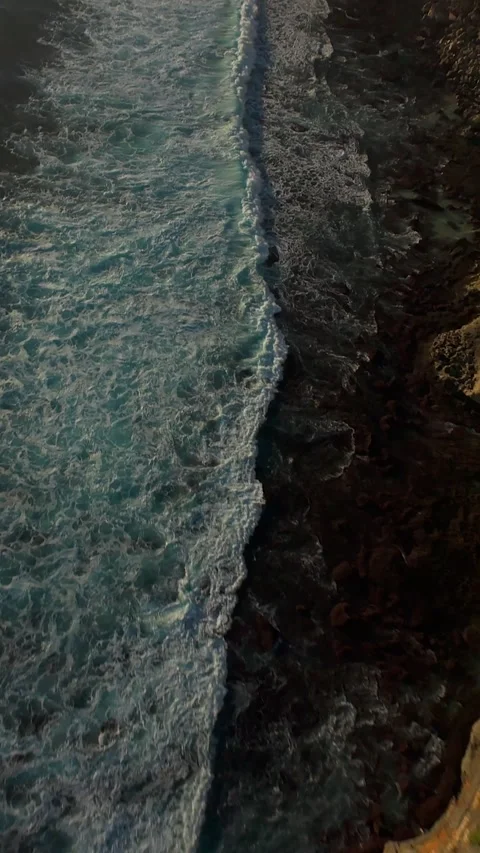 Vertical video. Extreme FPV Drone Dive Above Karang Boma Cliff At Sunset, First Stock Footage 336636647