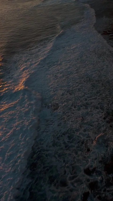 Vertical video. Extreme FPV Drone Dive Along Karang Boma Cliff At Sunset, First Stock Footage 336636725