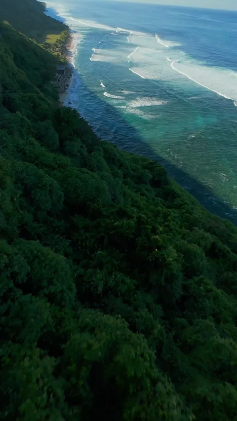 Vertical video. Extreme FPV Drone Dive Above Nyang Nyang Beach Cliffs, Fast Desc Stock Footage 336638228