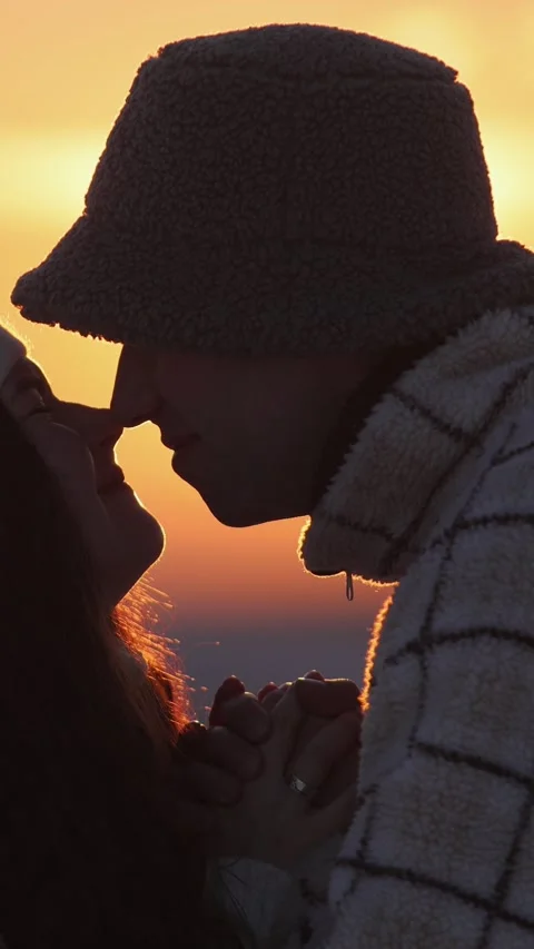 Vertical video. The faces of a man and a woman who are in love touch their noses Video stock 303257981