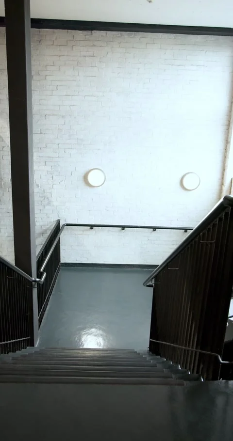 Vertical video: Facing deadline Diverse team entering stairwell discussing Stock Footage 346718577