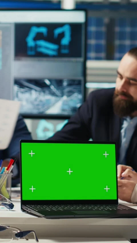 Vertical video Factory engineers refining production layouts using chroma key Stock Footage 306050696