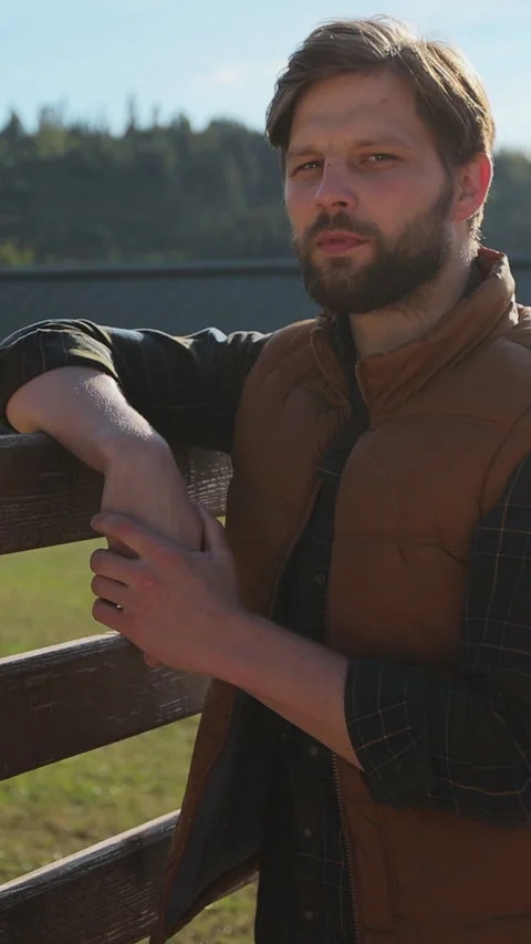 Vertical video. Farm Life: Close up a Young Farmer Embracing Stock Footage 344631134