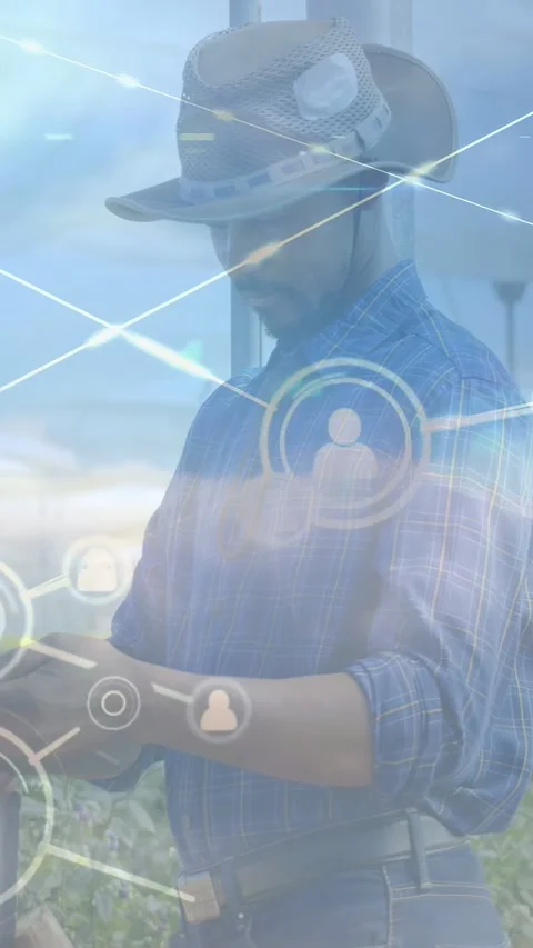 Vertical video: Farmer operating handheld and activating digital node overlay, Stockbeeldmateriaal 333451029
