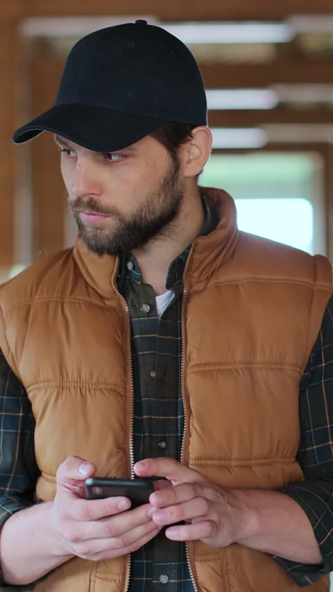 Vertical video. Farmer owner checking animal feedlots making notes on smartphone Stock Footage 344629479