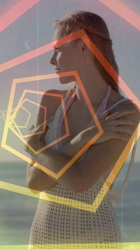 Vertical video: Fashion model posing on beach pentagons drifting across face Stock Footage 332823323