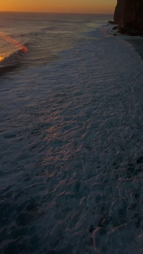 Vertical video. Fast FPV Drone Dive Above Karang Boma Cliff During Golden Sunset Stock Footage 336636816