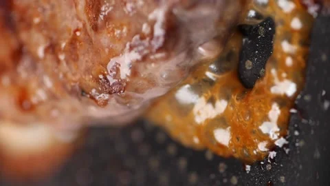 Vertical video. Fat flows and brown bubbles form from the meat when heated. Stock Footage 229492497
