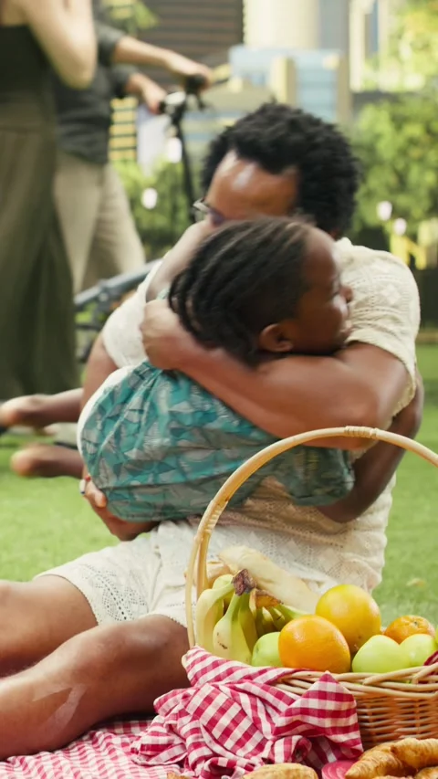 Vertical Video Father lifting and hugging boy while mother laughs on checkered Stock Footage 341472747