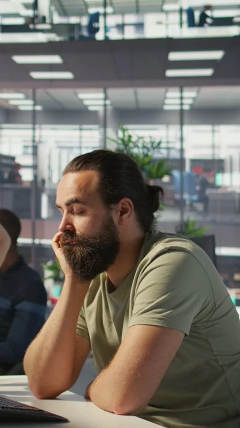 Vertical video Fatigued software engineer caught asleep at desk by manager Stock Footage 319485132