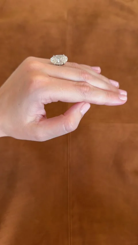 Vertical video featuring a luxurious oval engagement ring in profile angle Stock Footage 314786709