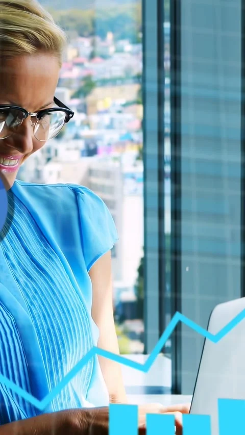 Vertical video: Female analyst typing at laptop animating charts over screen for Stock Footage 335263800