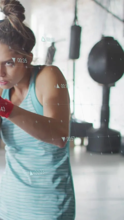 Vertical video: Female boxer responding to timer, striking and tucking, training Stock Footage 333259793