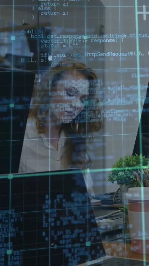 Vertical video: Female coder glancing monitor then typing on laptop to enter Stock Footage 334549882