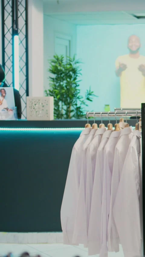 Female customer looking at merchandise in clothing store, shopping