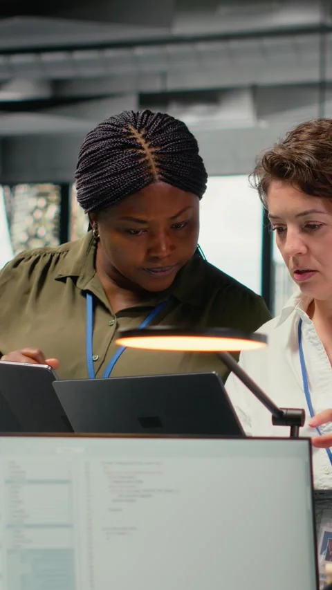 Vertical video Female engineers in startup office using AI technology driving Stock Footage 323141958
