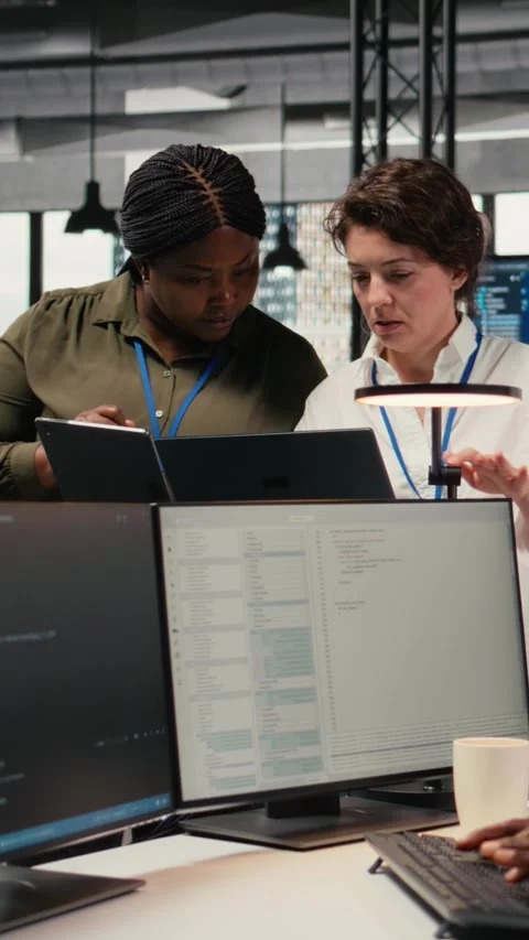 Vertical video Female engineers in startup office using AI technology driving Stock Footage 323142027