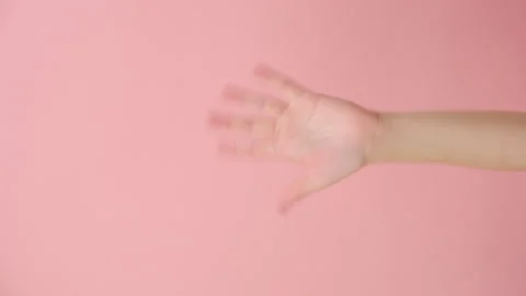 Vertical video of female hand waving and greeting as notices someone friend Stock Footage 253499082