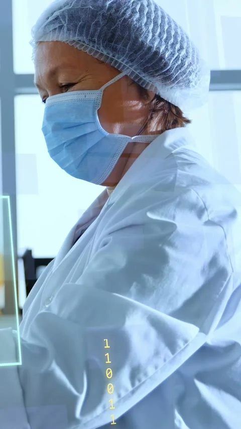 Vertical video: Female lab tech leaning at bench, starting input and showing HUD Stock Footage 335264062