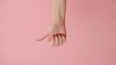 Vertical video of female making thumb up gesture, demonstrates agreement Stock Footage 253499893
