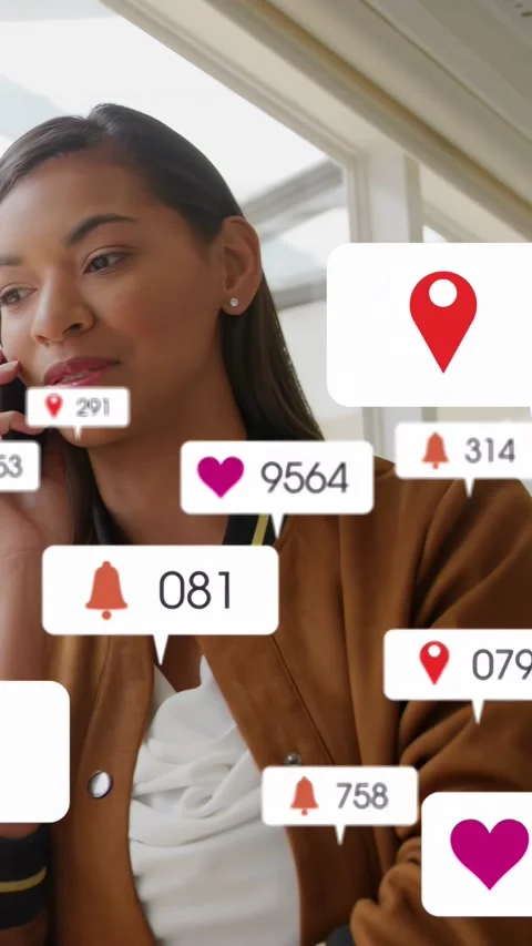 Vertical video: Female model by windows social media hearts rising while Stock Footage 333222094