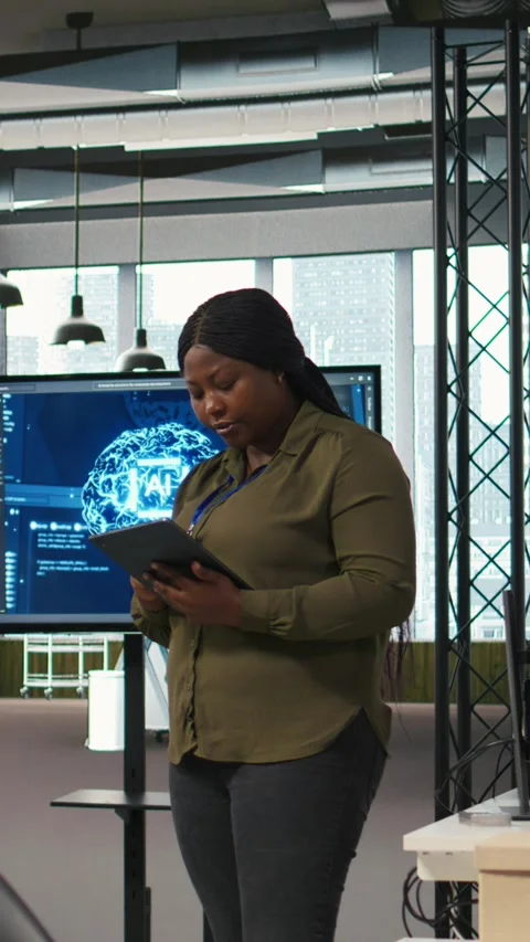 Vertical video Female programmer coding AI algorithms on tablet to debug Stock Footage 312708158