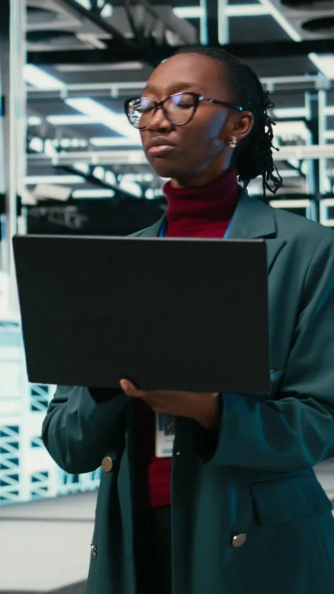 Vertical video Female programmer walking in data center engineer uses AR Video stock 329530019