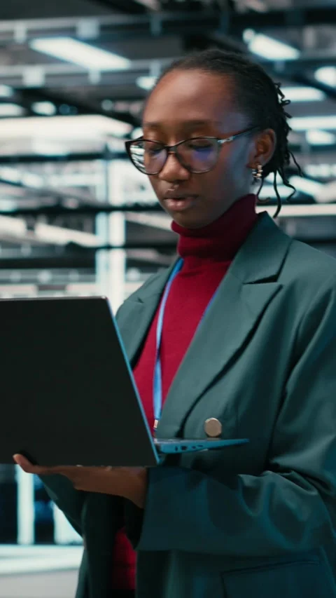 Vertical video Female programmer walking in data center engineer uses AR Stock Footage 329649753