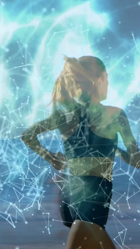 Vertical video: Female runner starting run by sea, causing teal glow and node Stock Footage 333978062