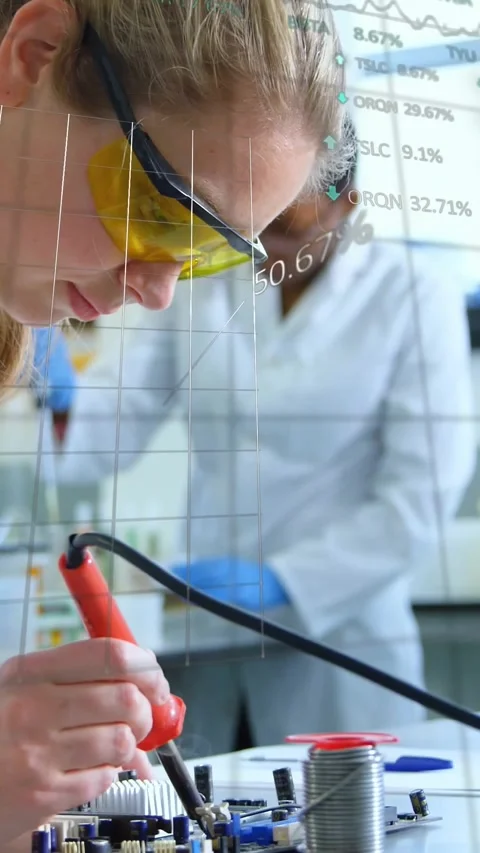 Vertical video: Female tech leaning and soldering PCB for tech QA, with data Stock Footage 330655704