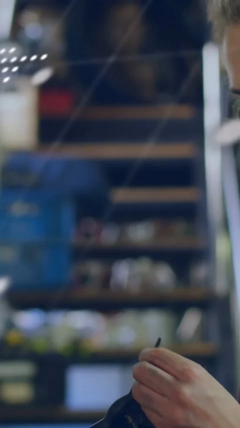 Vertical video: Female tech tapping device testing part for repair dotted map Stock Footage 332747532