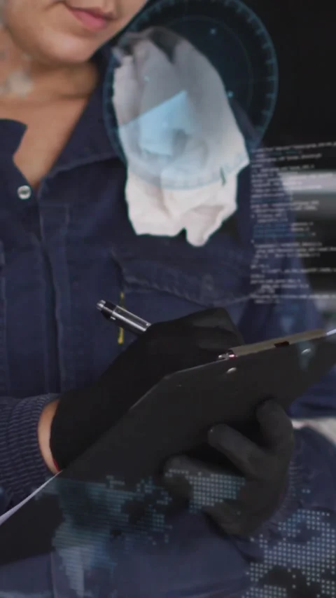 Vertical video: Female tech writing repair notes after alert, HUD code waveforms Stock Footage 329962294