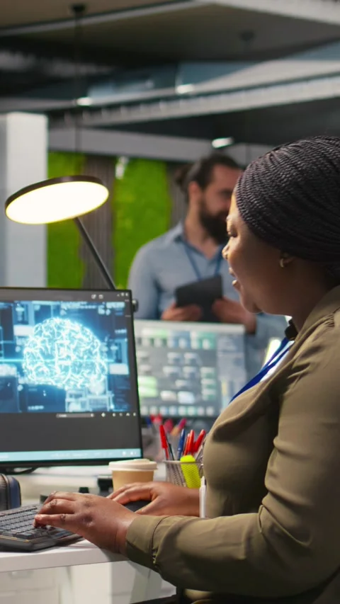 Vertical video Female technician using computer to write code, developing Stock Footage 312769411