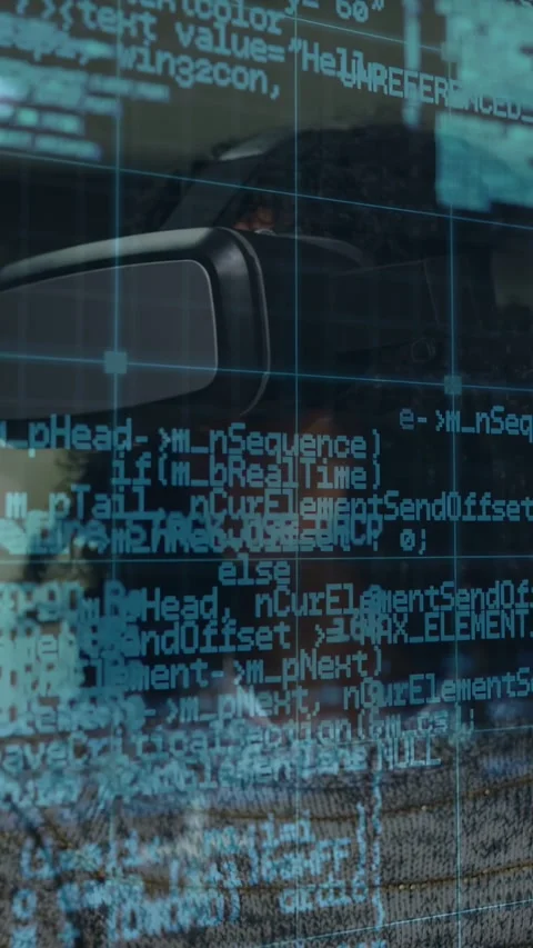Vertical video: Female in VR headset emerging while scrolling cyan code overlay Stock Footage 333006437