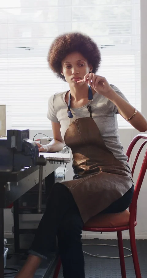 Vertical video of female worker drawing design of jewellery in slow motion Stock Footage 345319690