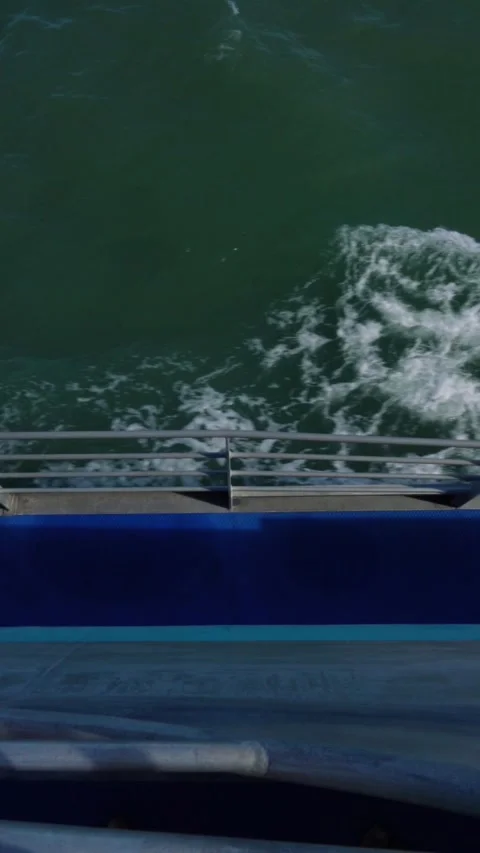 Vertical video of Ferry boat sailing creating waves and foam in the great Stock-Footage 330879064