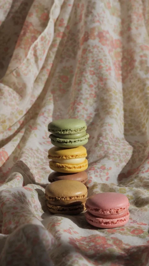 Vertical video of a few macaroons piled up, with shadows Stock Footage 233255866