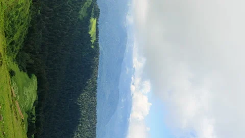 Vertical video. Field and mountains with forests. Zoom. TimeLapse. Sochi, Russia Stockbeeldmateriaal 85882312