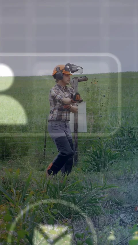Vertical video: Field tech walking fence, inspecting box for farm sensor data, Video stock 333528332