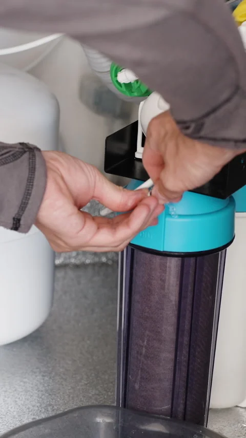 Vertical video. Filters under the kitchen sink, a reverse osmosis system with a Stock Footage 250670652