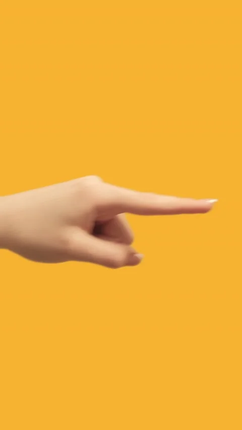 Vertical video finger pointing next hand on orange Stock Footage 231052639