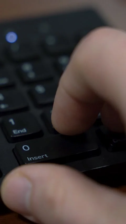 Vertical Video Finger Pressing Key on Computer Numeric Keypad Stock Footage 323399243