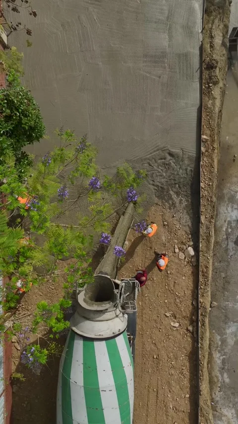 Vertical Video: First concrete is poured into the foundation for a multi-story Stock Footage 297665822