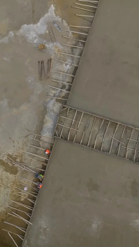 Vertical Video: The first concrete is poured into the foundation of a Stock Footage 297666609