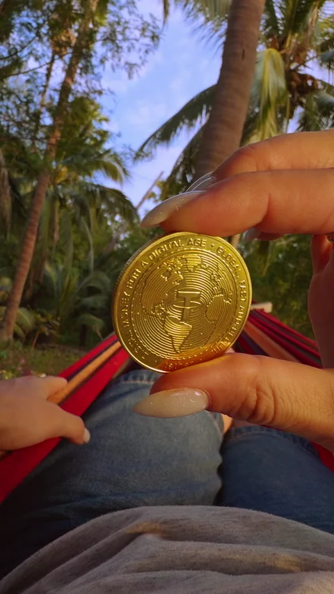 Vertical video. First Person View Holding Golden Tether Coin While Resting in Ha Stock Footage 326971121